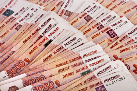 Heap of five thousand Russian rubles banknotes surface top view background