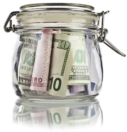 Money glass jar full of savings banknotes isolated on white background  Business concept の写真素材
