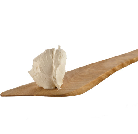 mascarpone cheese on wooden spatula close up Isolated on White Backgroundの写真素材