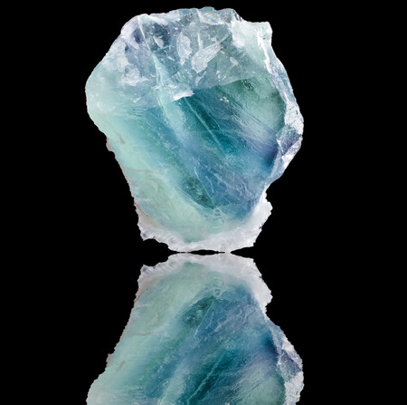 Blue- Green Fluorite with reflection on black surface backgroundの写真素材