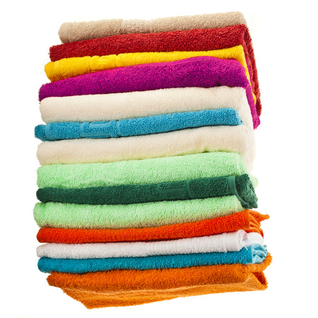 stack of colorful towels isolated on whiteの写真素材