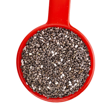 chia seeds in red scoop close up isolated on whiteの写真素材