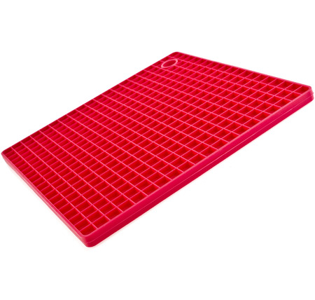 Red Kitchen silicone place mat hot dishes close up isolated on white backgroundの写真素材