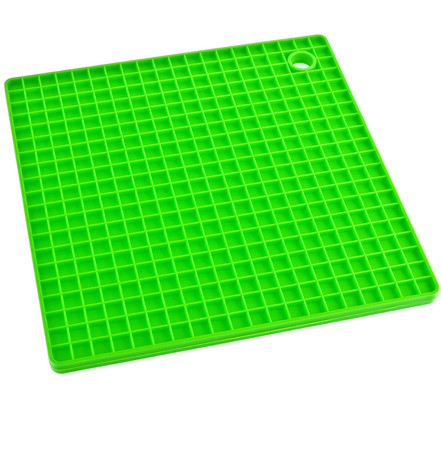 Green Kitchen silicone placemat stand for a hot dishes close up isolated on white backgroundの写真素材