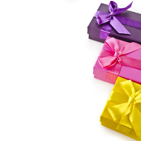 Border rows of colorful gift boxes with bows isolated on a white backgroundの写真素材