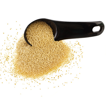 Amaranth popping, gluten-free, grain cereal in black scoop close up isolated on white backgroundの写真素材