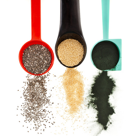 superfoods heap pile collection close up in colorful scoop top view surface isolated on white backgroundの写真素材