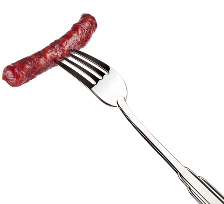 smoked sausage on a fork against white backgroundの写真素材