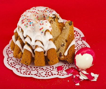 easter bread cake and colored egg on red backgroundの写真素材