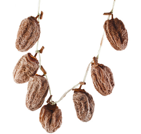 hanging bunch dried persimmon fruit isolated on white backgroundの写真素材