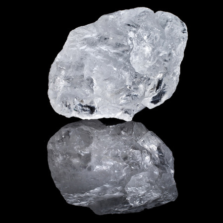 single white transparent Quartz, Rock Crystal with reflection on black surface backgroundの写真素材