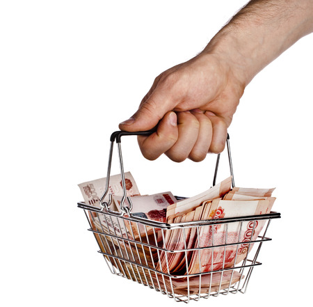 Man s hand holding a Money Rubles of the Russian Federationin your shopping basket cart isolated on white backgroundの写真素材