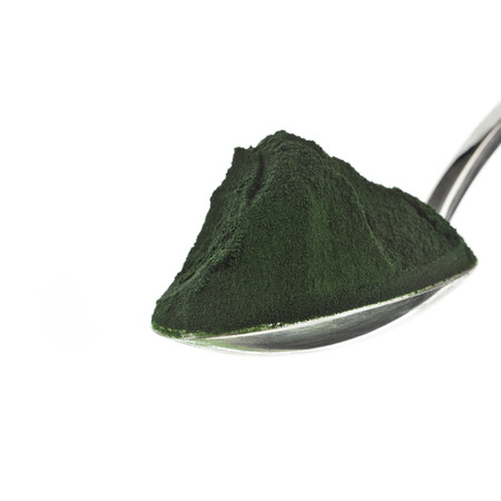 Spirulina powder - algae, nutritional supplement in spoon isolated on white backgroundの写真素材