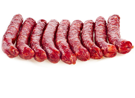 Stack of smoked sausages isolated on white backgroundの写真素材