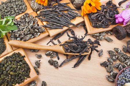 Collection of different tea  green,black, herbal  on kitchen wooden table background, top viewの写真素材