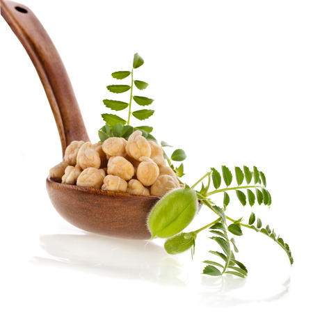 chickpeas seed over wooden spoon isolated on white backgroundの写真素材