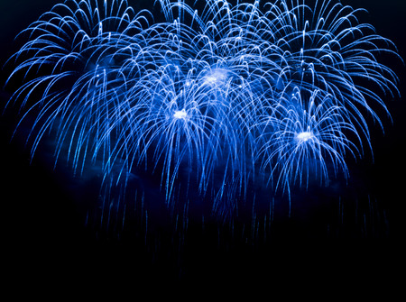 Blue colorful fireworks on the black sky backgroundの写真素材