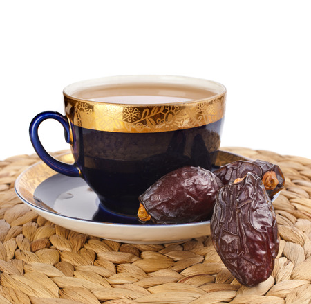 Black coffee with dates - a middle eastern refreshment drink isolated on a white backgroundの写真素材