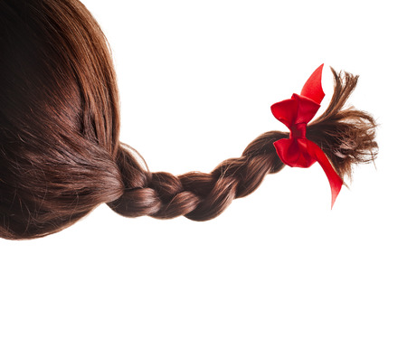 natural hair braided with red ribbon bow isolated on white backgroundの写真素材