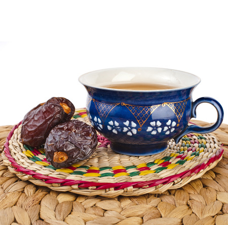 Black coffee with dates - a middle eastern refreshment drink isolated on a white backgroundの写真素材