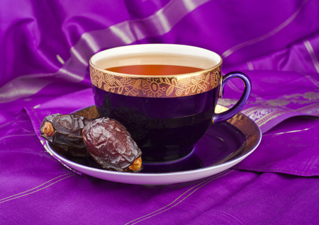 Ramadan eastern refreshment drink with dates on cloth tableの写真素材
