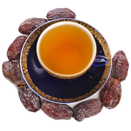 Black coffee with dates - a middle eastern refreshment drink isolated on a white backgroundの写真素材