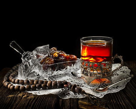 Ramadan festival in wooden table isolated on black backgroundの写真素材