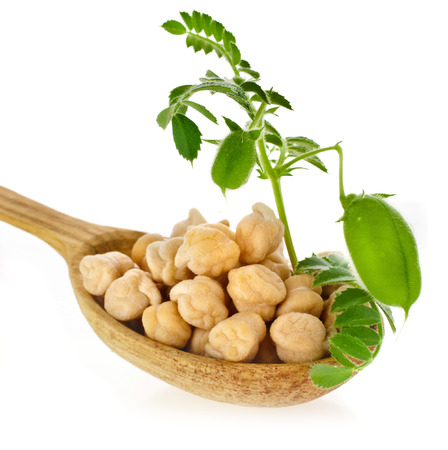 Chick peas over spoon isolated on white backgroundの写真素材
