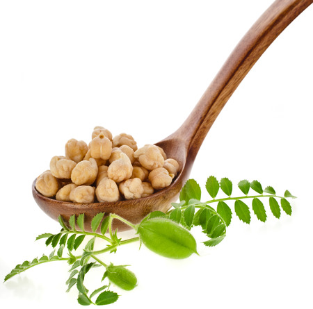Chick peas over wooden spoon isolated on white backgroundの写真素材