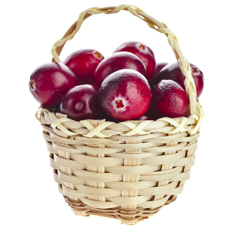 Cranberries in wicker basket isolated on white backgroundの写真素材