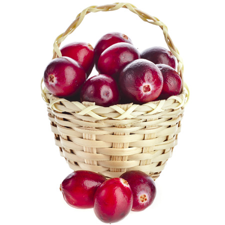 Cranberries in wicker basket isolated on white backgroundの写真素材