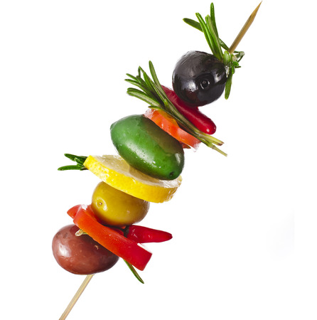 olives with vegetables, herbs, spices in wooden stick isolated on a white backgroundの写真素材