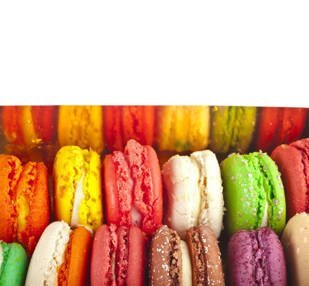 Assortment of multicolored macaroon in cardboard box . top view isolated on whiteの写真素材