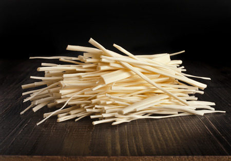 cheese spaghetti heap on wooden table close upの写真素材