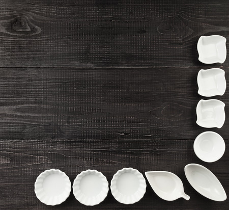 Several Sauce boat on black wooden rustic surface background top viewの写真素材