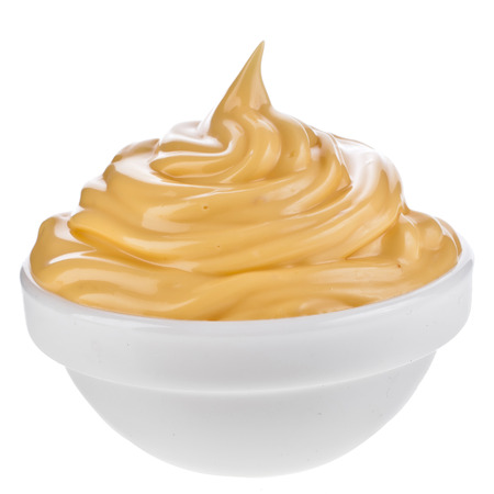 cheese sauce in bowl isolated on white backgroundの写真素材