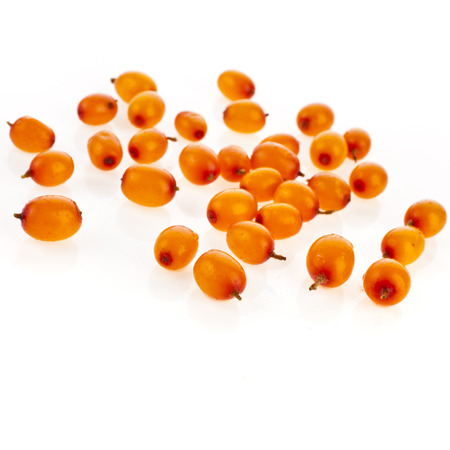 ripe sea buckthorn berries close up isolated on white backgroundの写真素材