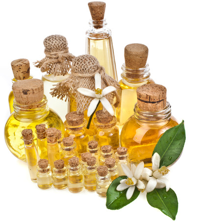 essential oil in bottles with fresh citrus flowers isolated on white backgroundの写真素材