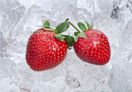 Sweet strawberries on ice cubes surfaceの写真素材