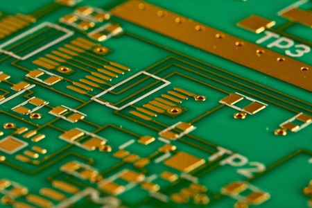 A multi layer radio frequency printed circuit board showing gold tracks and white silk screen print