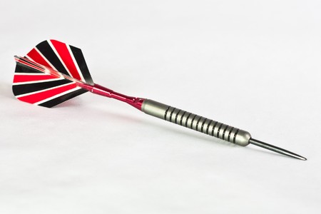 A single dart with a polished steel shaft and black, white and red feathers