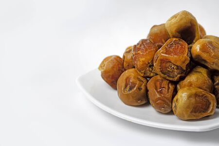 Sukari dates fruit on a white plate with a white background, Infinite depth of field, retouchedの写真素材