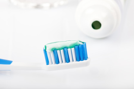 dental care equipment on white background, toothpaste, toothbrush, pastet tube, glass of water,...