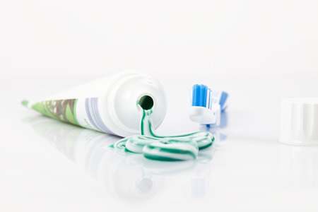 dental hygiene stuff, with sqeezed out toothpaste on paste tube and toothbrush,の写真素材