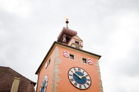 medieval church steeple with church clock in regensburg, germany