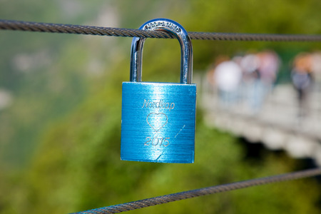 metallic blue lock on wire cable with nordkap an heart shape gravureの写真素材