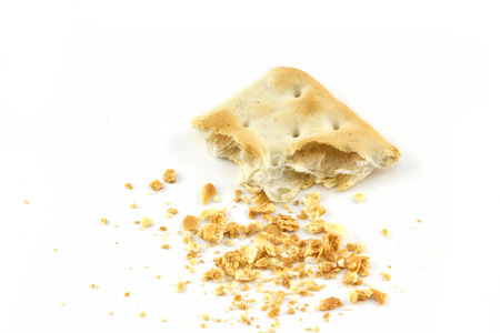 cracker with a bite and crumb isolated on white background