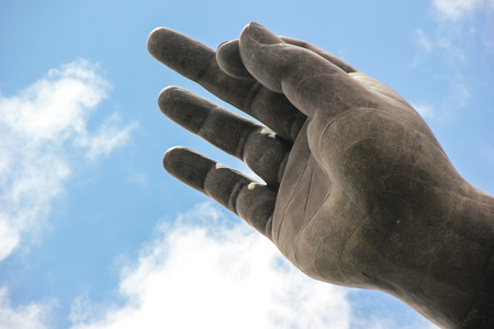 Buddha Hand on blue skye backgroundの写真素材