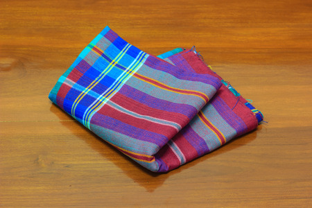 thai fabric on wooden floorの写真素材