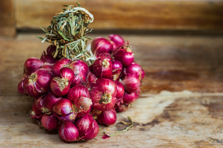 fresh shallots or onion on wood background.の写真素材
